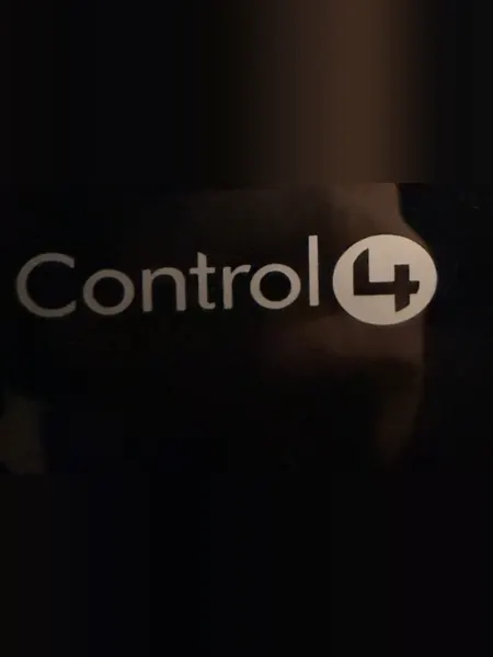 Control4 logo on the glossy black front of a Control4 unit