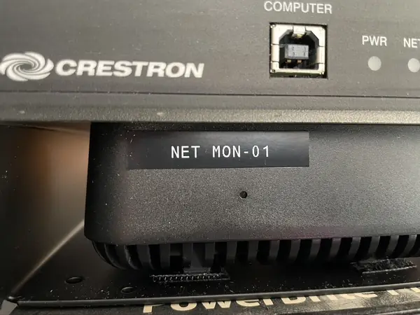 A device in the rack printed NET MON-01, the same name the system documents use