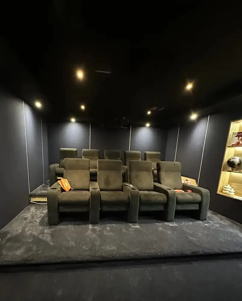 A finished 1Install cinema room with two rows of tiered recliners, the kind of room where LED walls for home cinemas now take the place of projection
