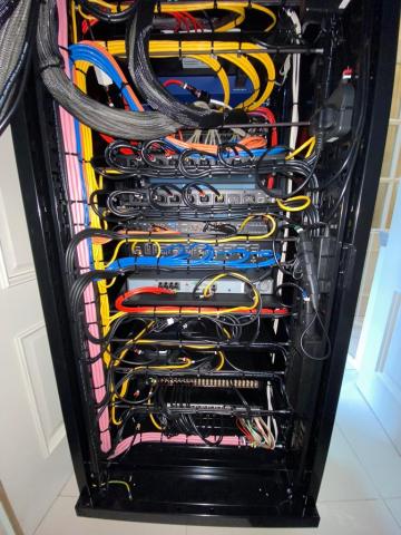 An equipment rack after our rescue work, with the cables dressed and colour coded