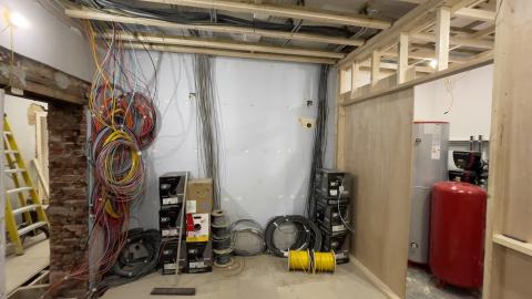 Bundles of first fix cable hanging in a room that is still being built