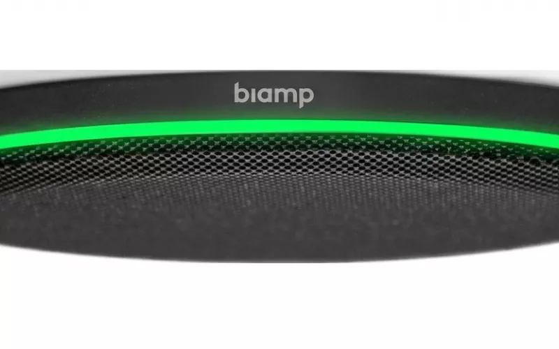 Product photo of a black Biamp Parlé TCM-X ceiling microphone with a green ring light, one of the Parlé ceiling microphones that support Biamp voice reinforcement through Parlé Voice Lift