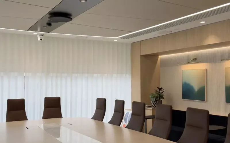 Executive boardroom with a long table and a display