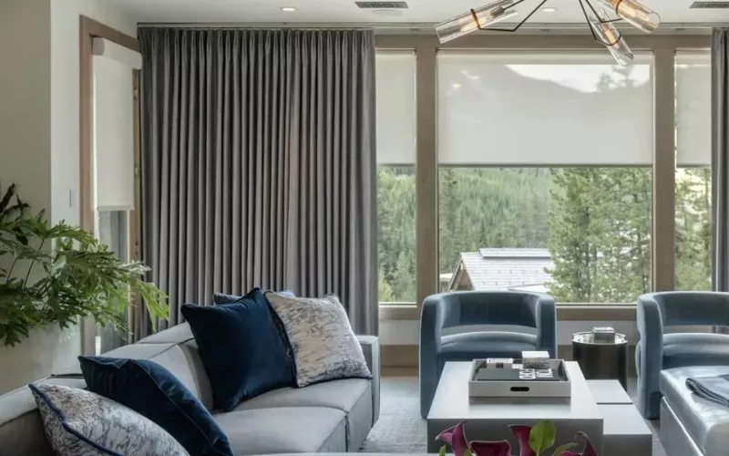 Living room with floor length curtains and blinds, the kind of room an installer sets up with Crestron Configure Pro