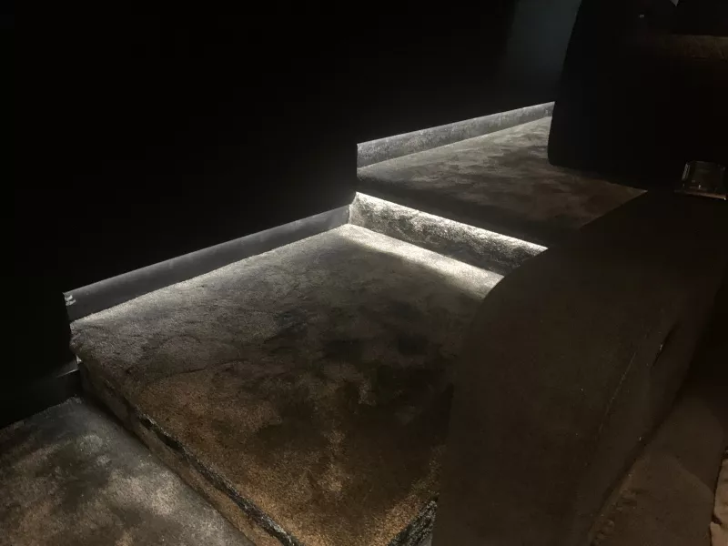 LED lighting along the edges of the carpeted steps in a Berkshire home cinema