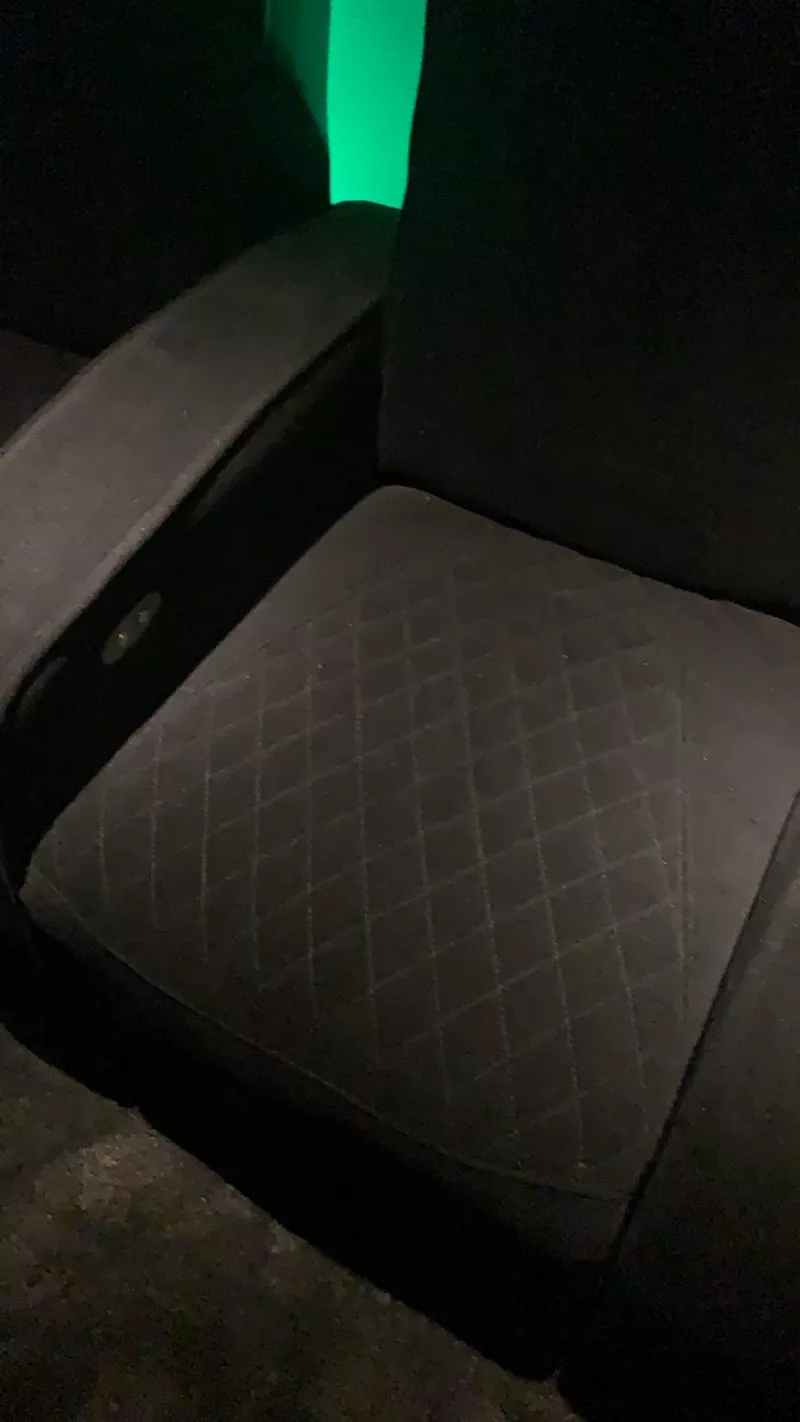 Diamond quilted seat cushion lit by green light from the wall behind