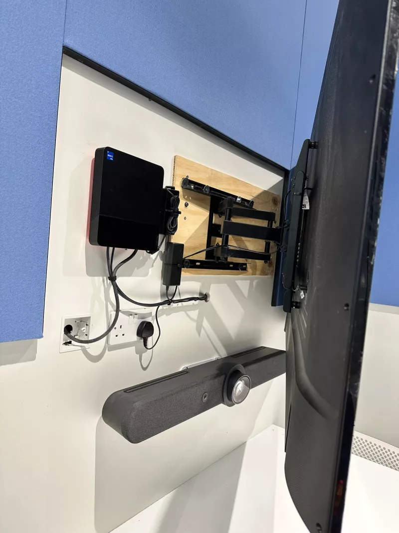 Mounting day: the Samsung screen pulled away from the wall on its arm, the timber board it is fixed to and a small black box alongside