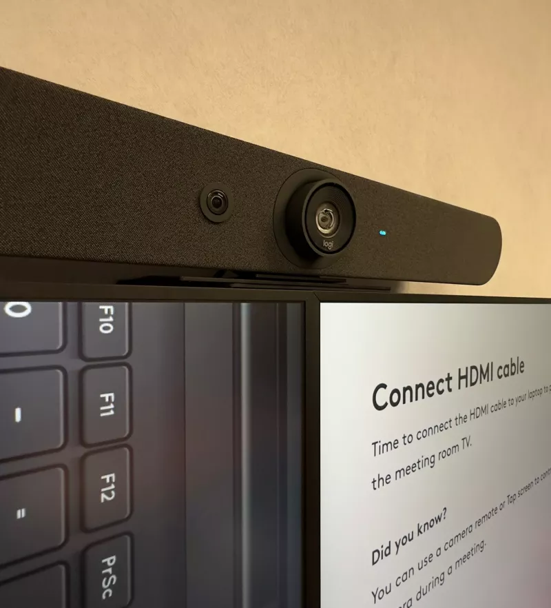 Up close, the camera lens of the Logitech bar above the two screens, which explain how to connect a laptop