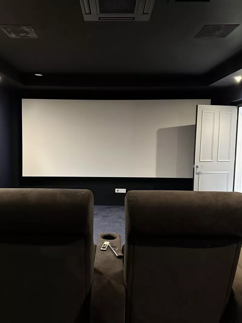 The projector screen seen from the back row of the home cinema