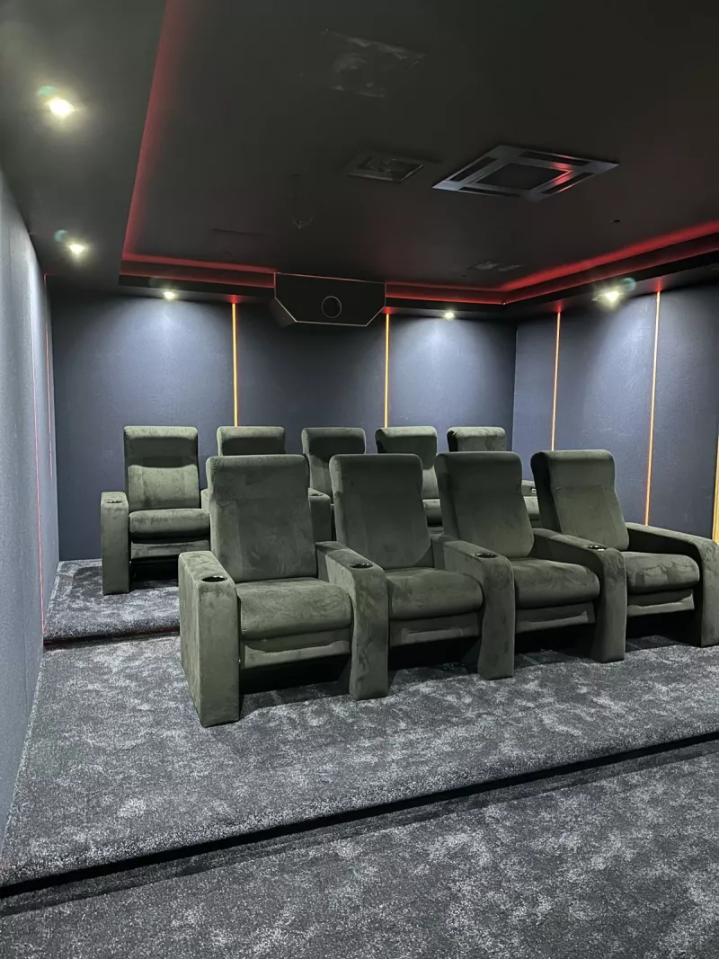 Nine reclining cinema seats in two rows under the LED lit ceiling