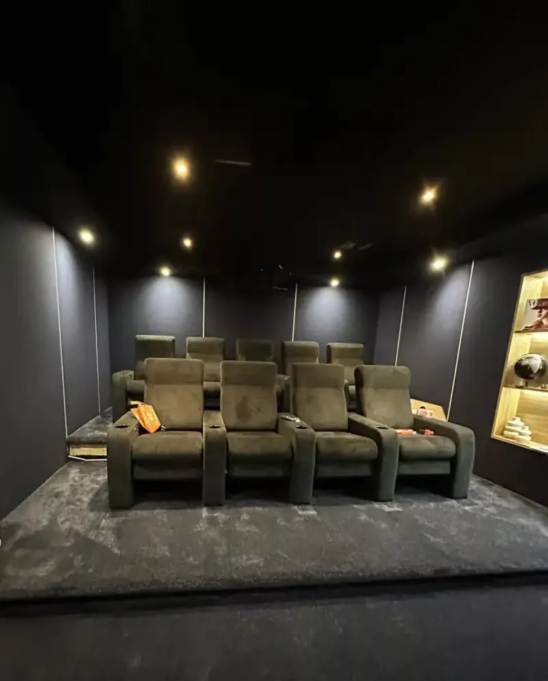 Two rows of recliners under warm downlights in the Finchampstead cinema