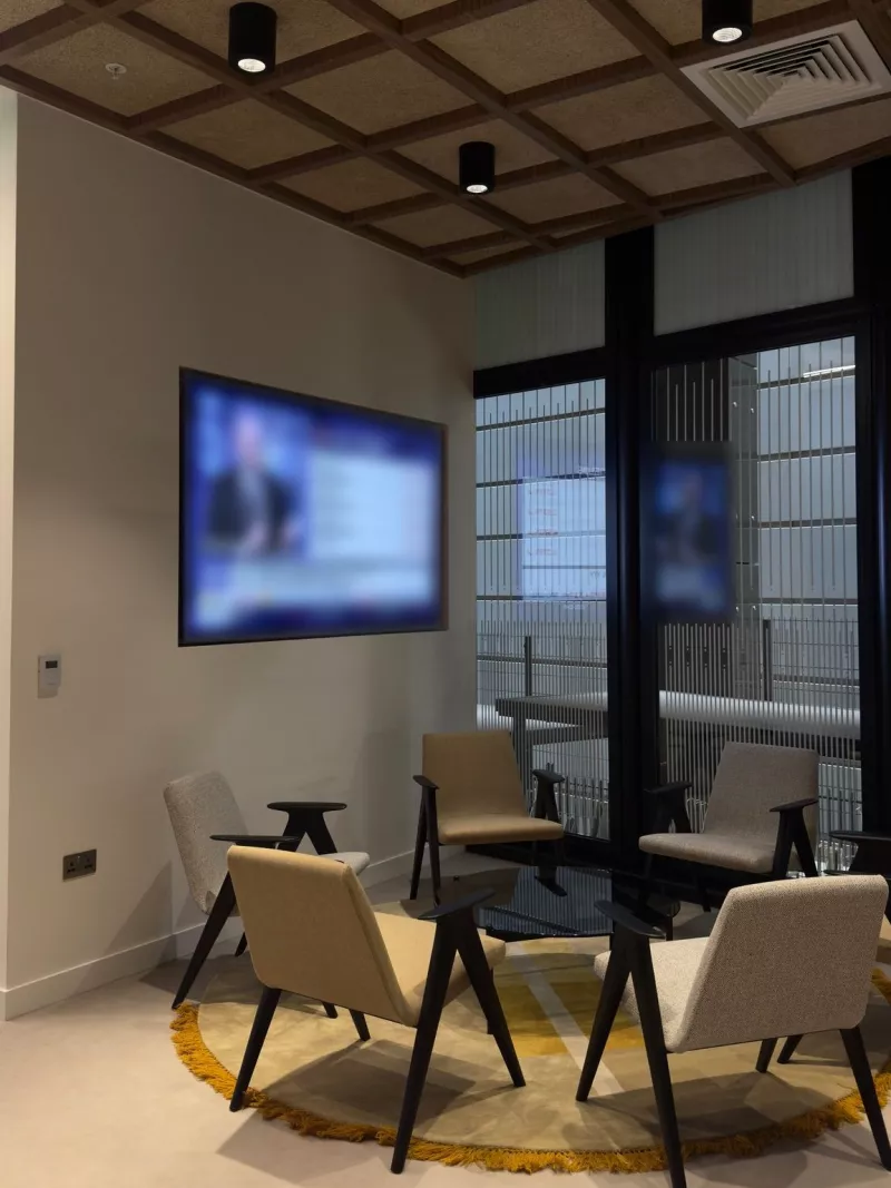 Office lounge with a wall mounted display