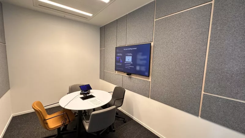 Small meeting room with a wall display, camera and table top touch controller