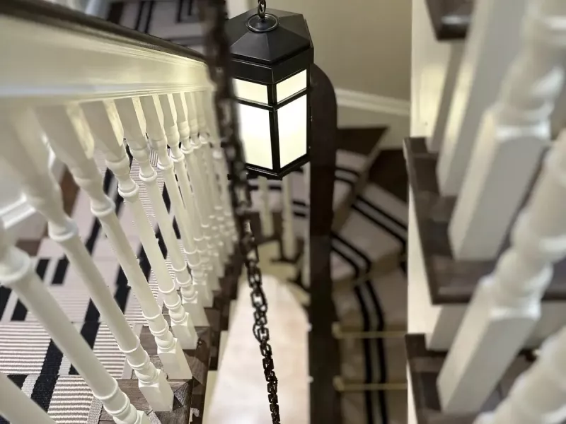 Lantern pendants lighting a sweeping staircase