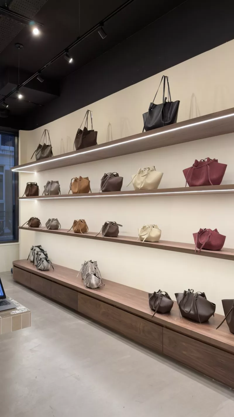 Walnut shelves with LED lighting controlled by Crestron in the Yuzefi store