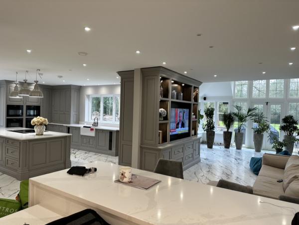 Open plan kitchen and family room with a TV built into the media unit