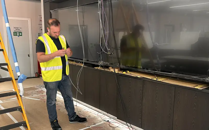 1Install engineer installing a display wall
