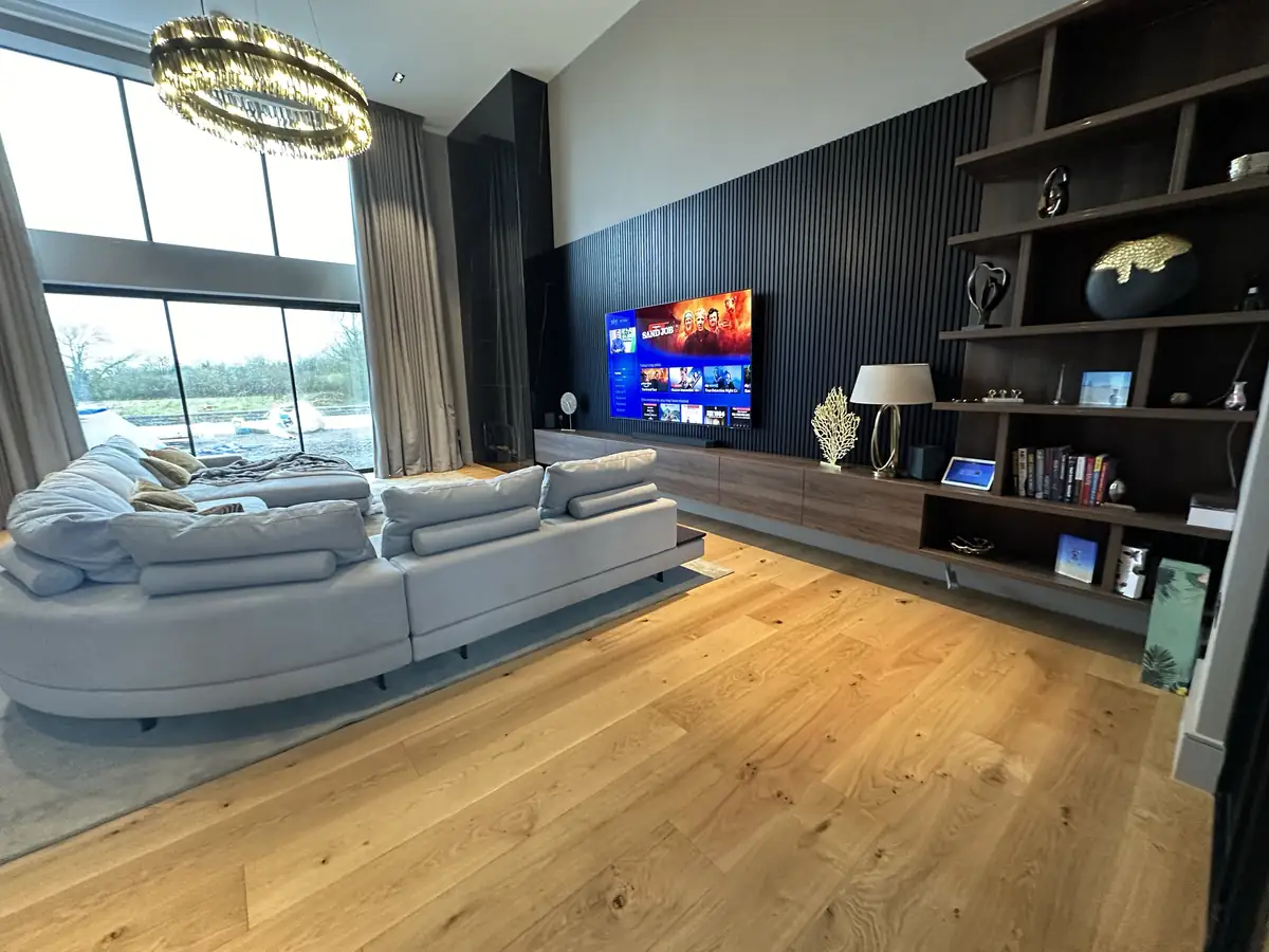 Double height living room with integrated TV and audio